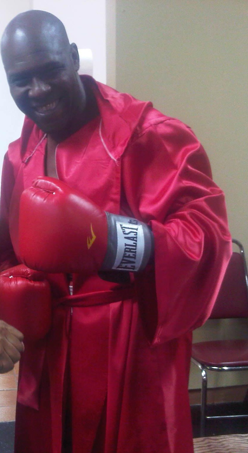 Benjai in a red boxing robe and gloves